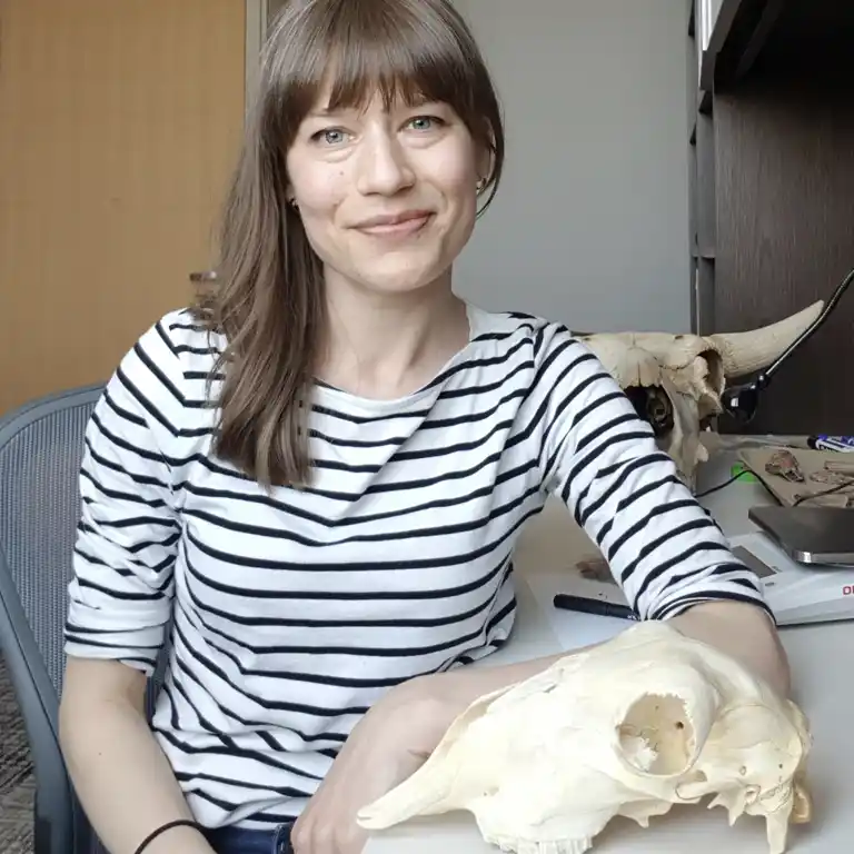 A photo of professor with animal skulls