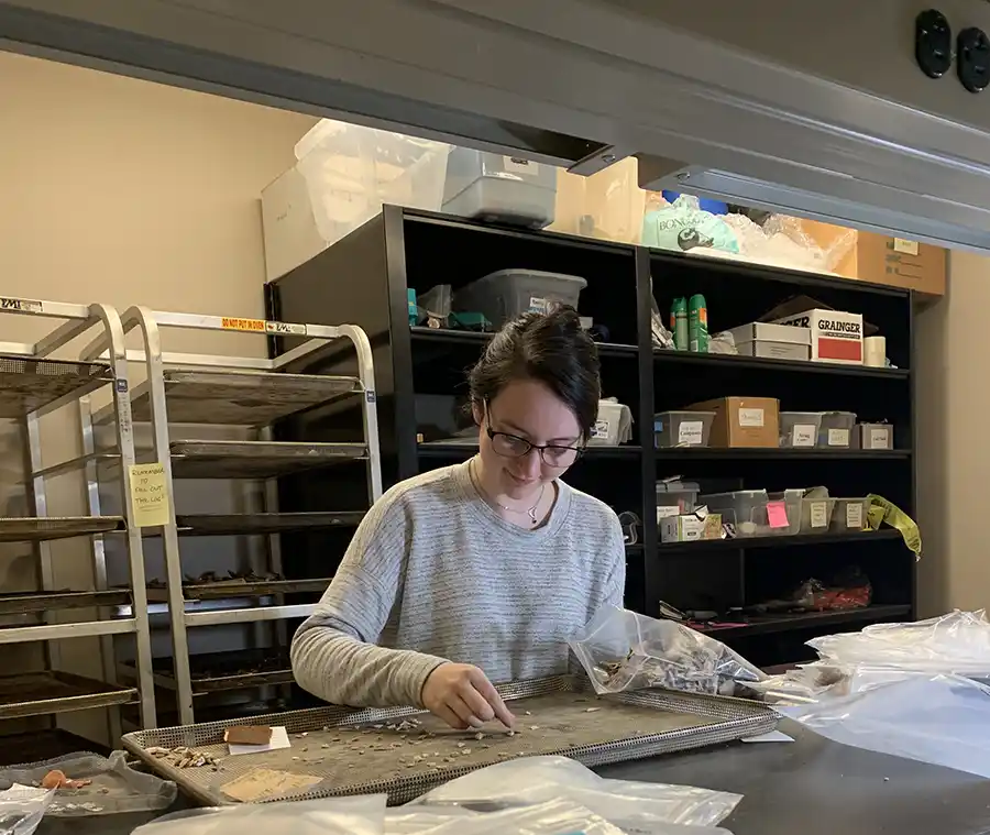 Hannah Maines sorts artifacts in Historical Archaeology Lab
